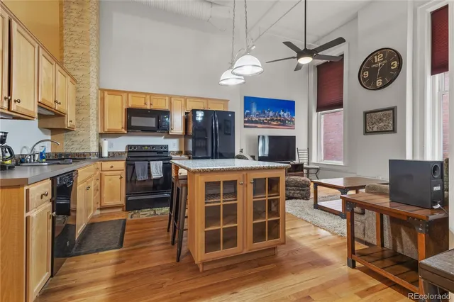 a view of kitchen with microwave stove top oven and cabinets