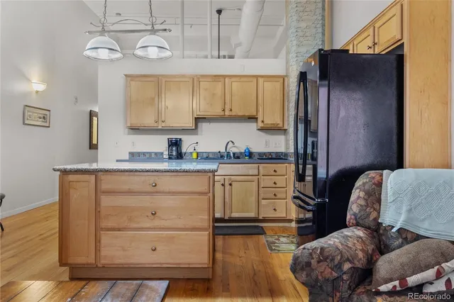a kitchen with a refrigerator and a stove top oven
