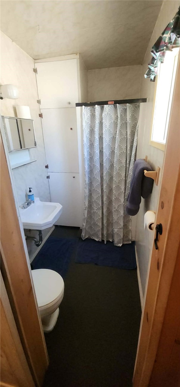 7515 Abner Lane Forest Ranch, CA 95942 - Photo 26 of 65 a bathroom with a sink a toilet a mirror and vanity