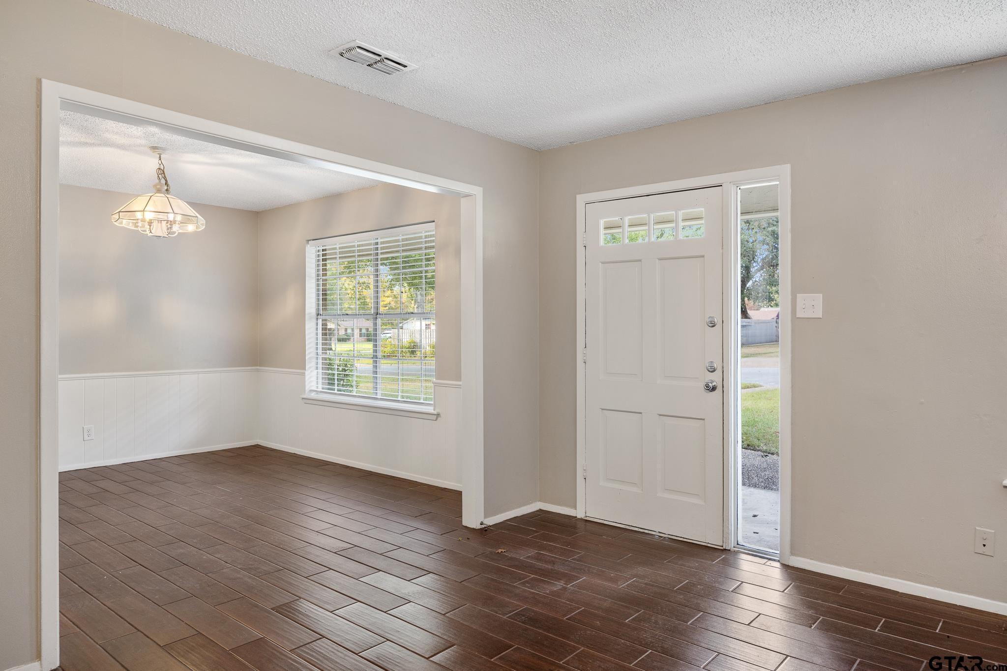 418 Boyd Lane Tyler, TX 75703 - Photo 4 of 25 a view of an empty room with wooden floor and a window