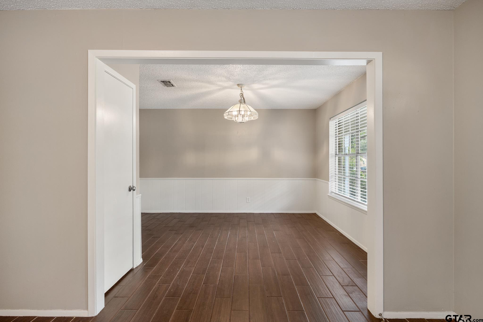 418 Boyd Lane Tyler, TX 75703 - Photo 7 of 25 a view of empty room with wooden floor and fan
