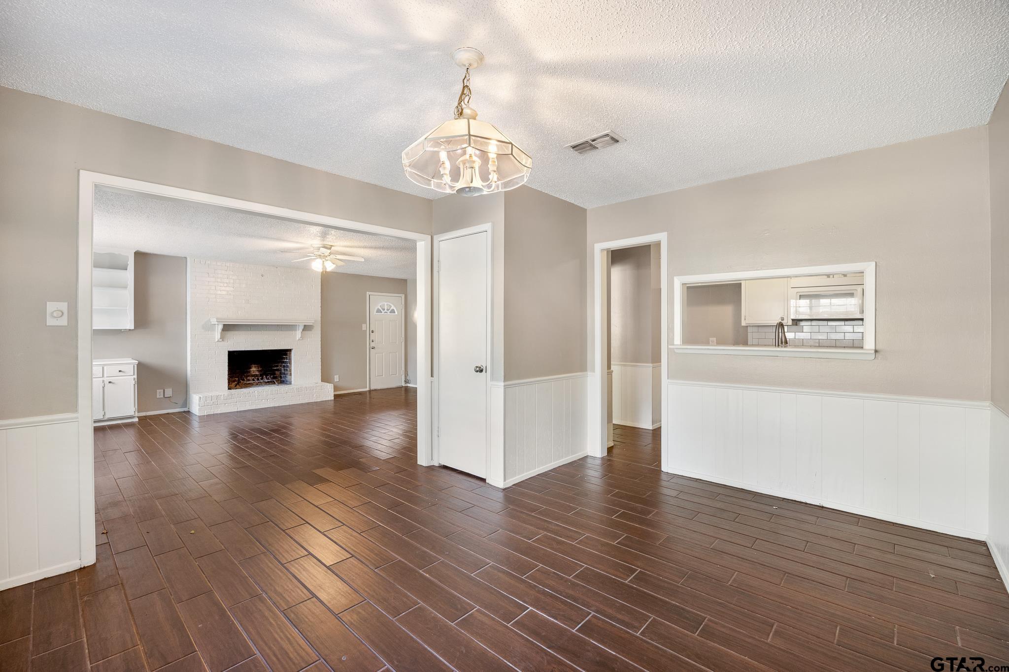 418 Boyd Lane Tyler, TX 75703 - Photo 8 of 25 a view of an empty room with wooden floor and a window