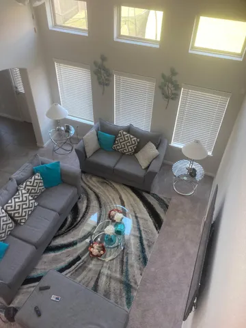 a living room with furniture and wooden floor