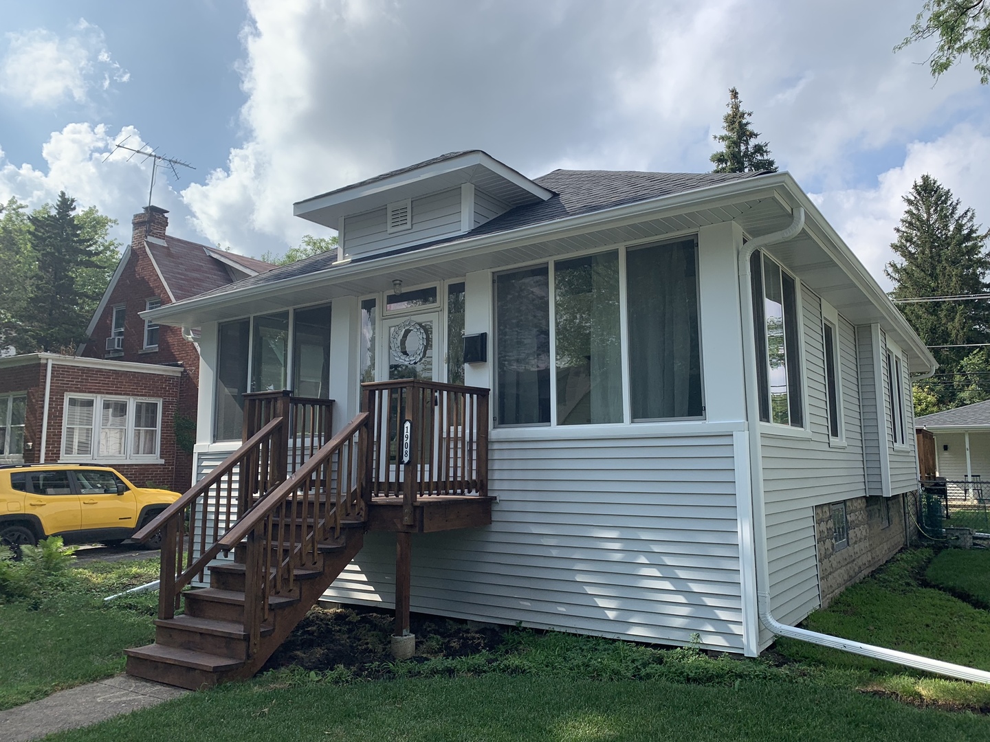 a front view of house with a garden