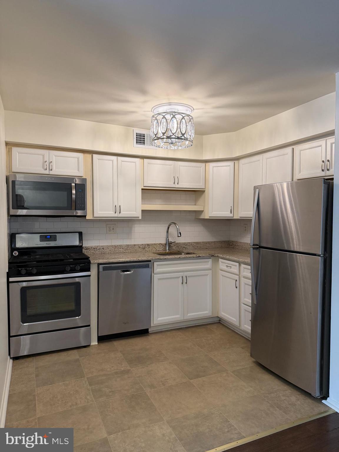 3766 Morrell Avenue Philadelphia, PA 19114 - Photo 2 of 14 a kitchen with stainless steel appliances granite countertop a refrigerator and a stove top oven