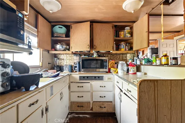 a kitchen with sink cabinets and chandelier
