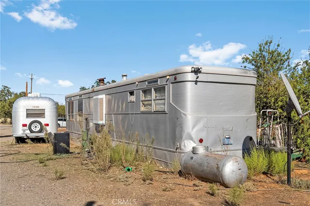 a view of a house with backyard sitting area and garden