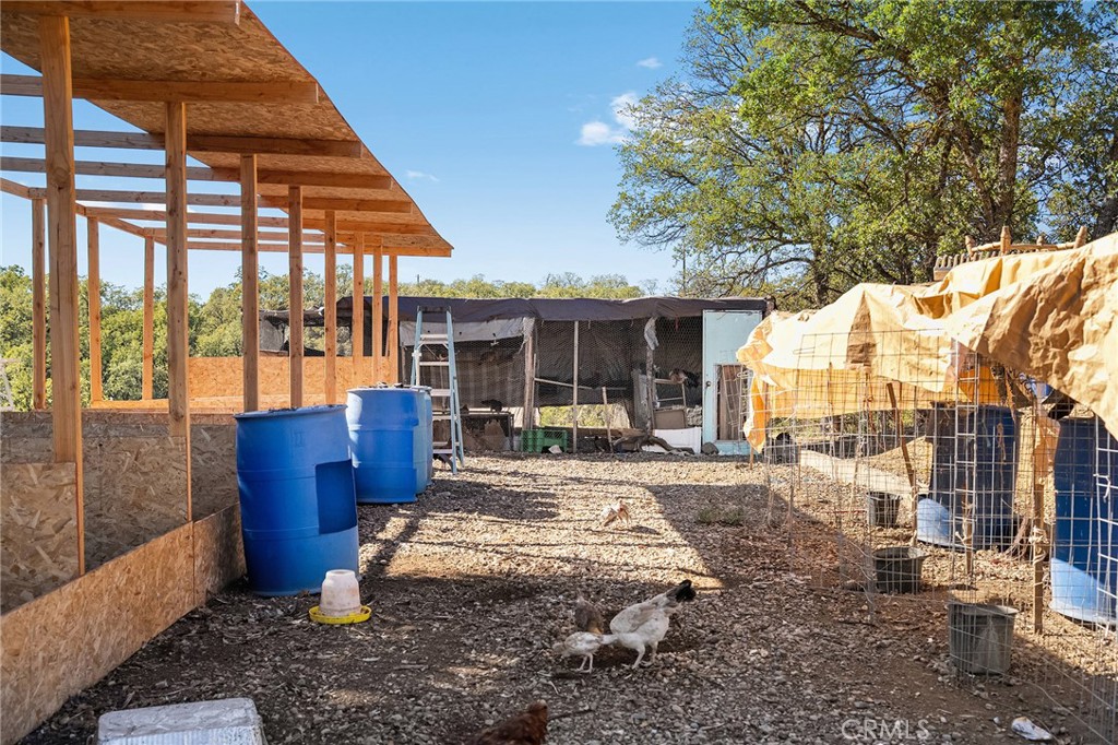 16925 Basler Road Cottonwood, CA 96022 - Photo 47 of 55 a view of a house with backyard sitting area and garden