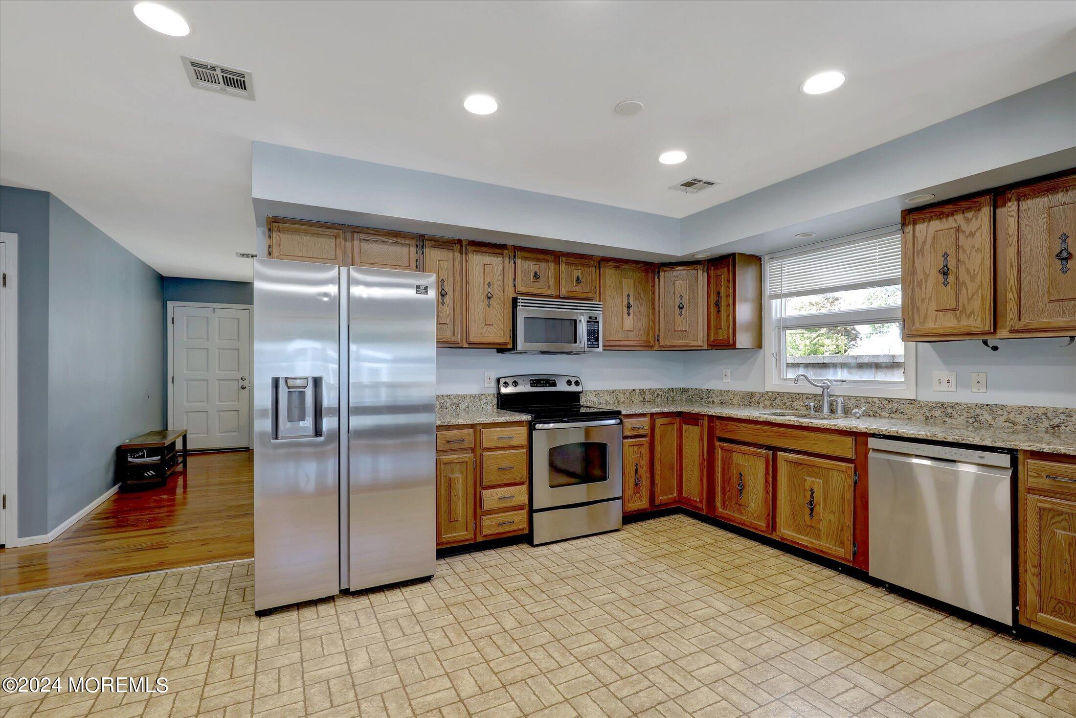 25 Hulse Landing Road Brick, NJ 08723 - Photo 8 of 28 a kitchen with stainless steel appliances granite countertop a refrigerator and a stove top oven