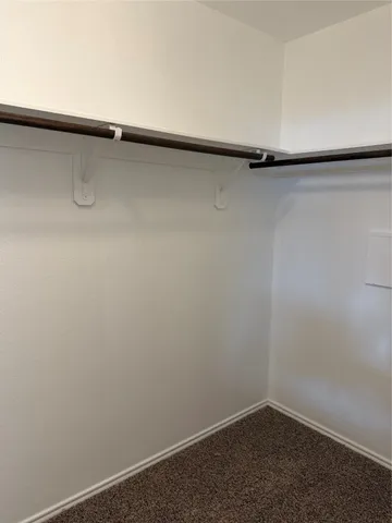 an empty room with a fireplace and windows