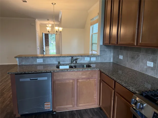 a kitchen with cabinets appliances and a counter top