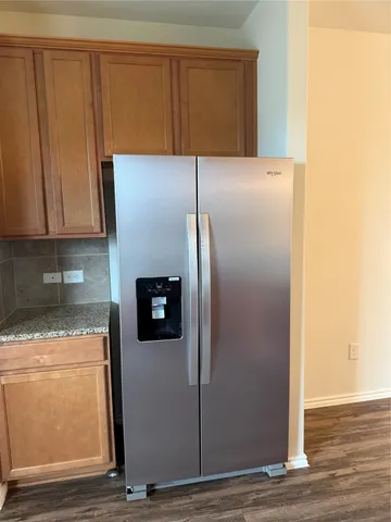 a kitchen with a refrigerator and cabinets