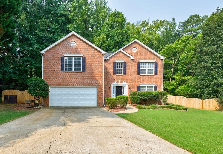 715 Spring Ridge Court Kennesaw, GA 30144 - Photo 1 of 1 a front view of a house with a yard and garage