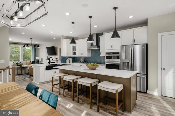 a large kitchen with kitchen island a dining table and chairs