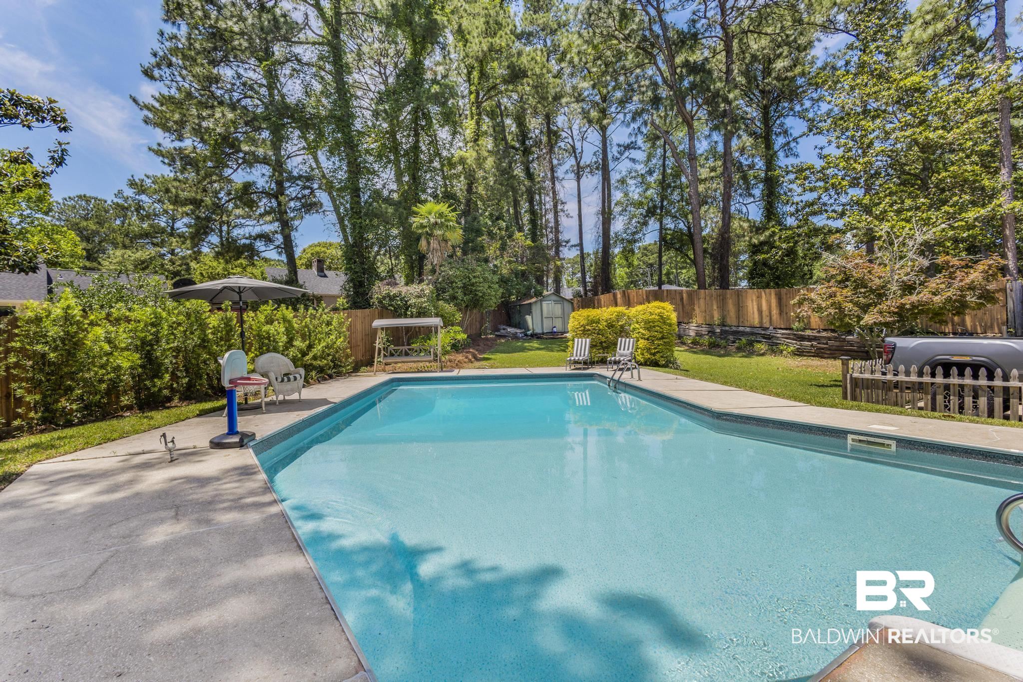 83 Caisson Trace Daphne, AL 36527 - Photo 58 of 63 Rectangular in-ground swimming pool featuring a concrete surround