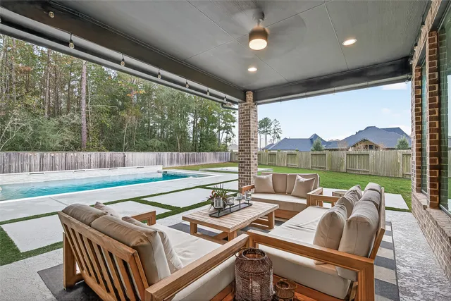 a living room with furniture and a floor to ceiling window