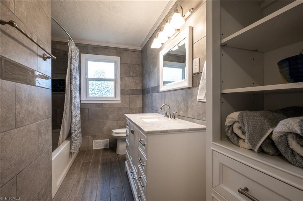 3230 Old 60 Ronda, NC 28670 - Photo 14 of 24 Completely renovated full bath with soaker tub, ceramic walls, floor and niches as well as new lighting, vanity with marble top and linen cabinet.