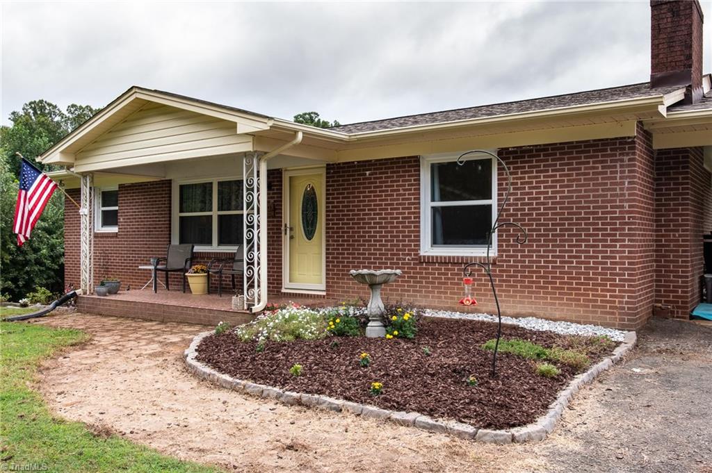 Covered front porch and small garden give this home curb appeal. 