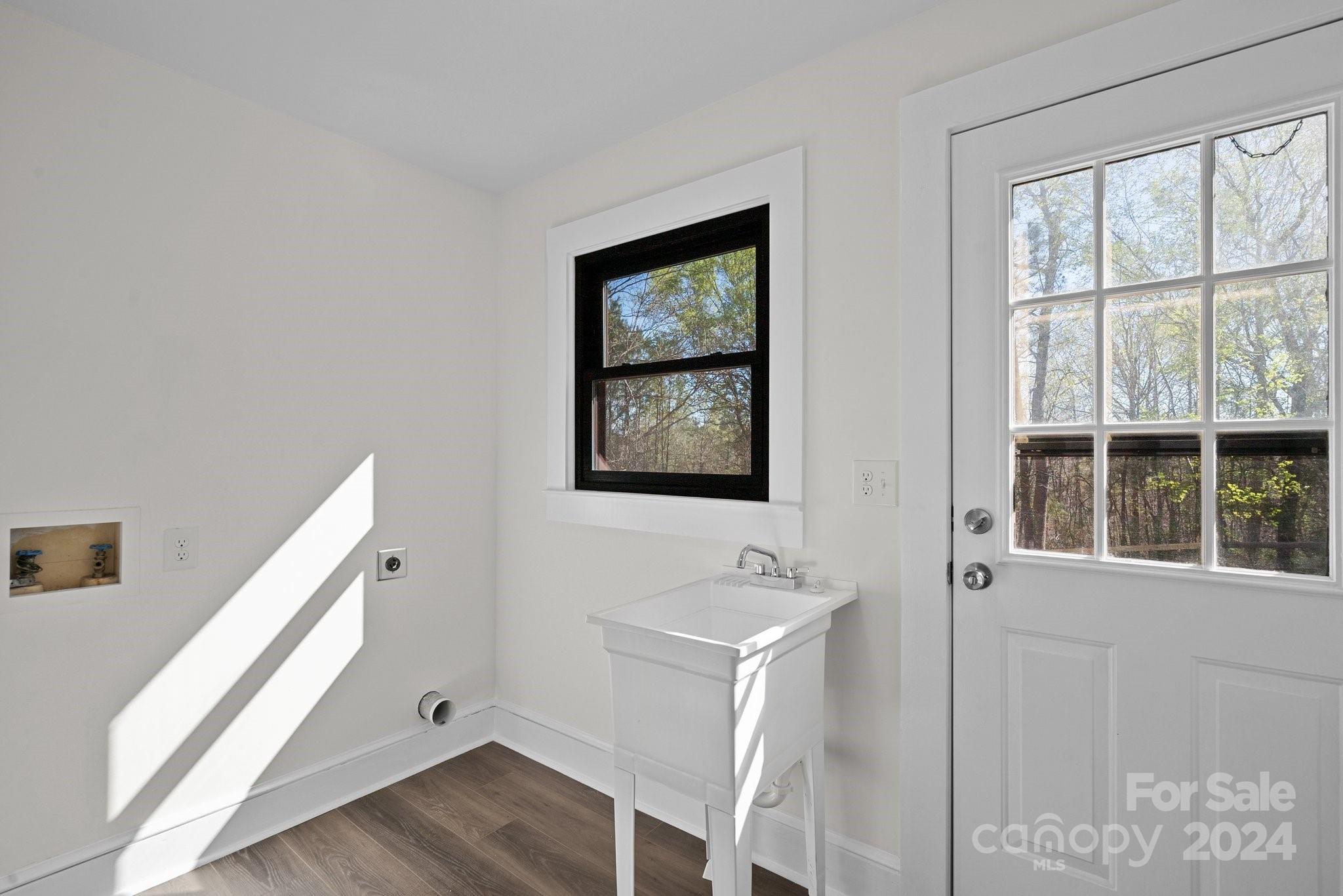 1820 Baber Road, Unit 4 Rutherfordton, NC 28139 - Photo 11 of 28 a bathroom with a sink a mirror and a window