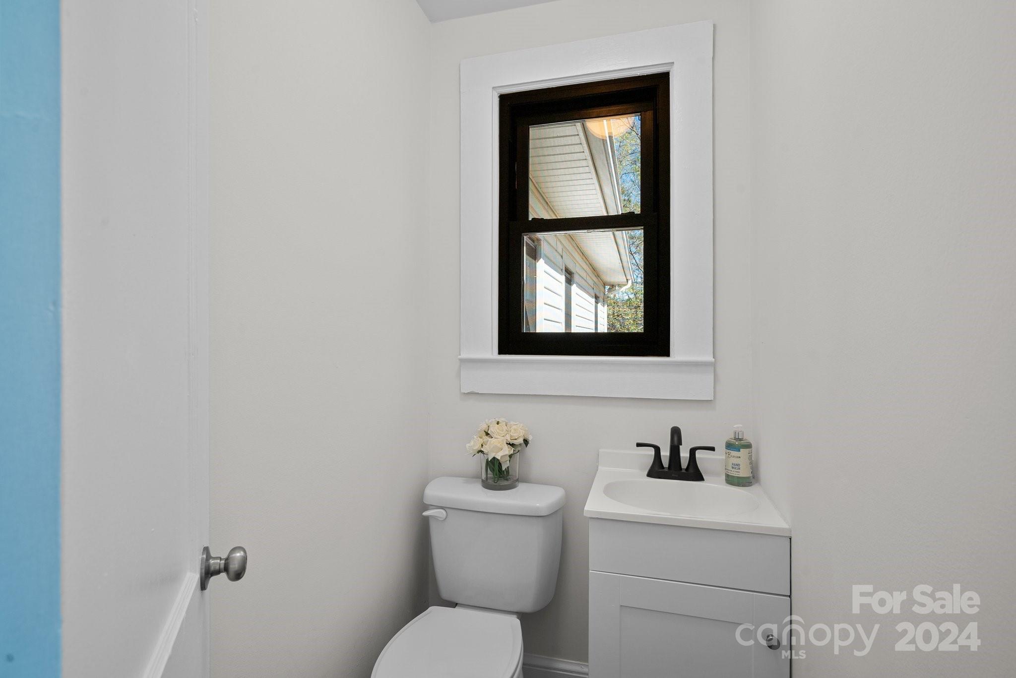 1820 Baber Road, Unit 4 Rutherfordton, NC 28139 - Photo 12 of 28 a bathroom with a toilet a sink and a window