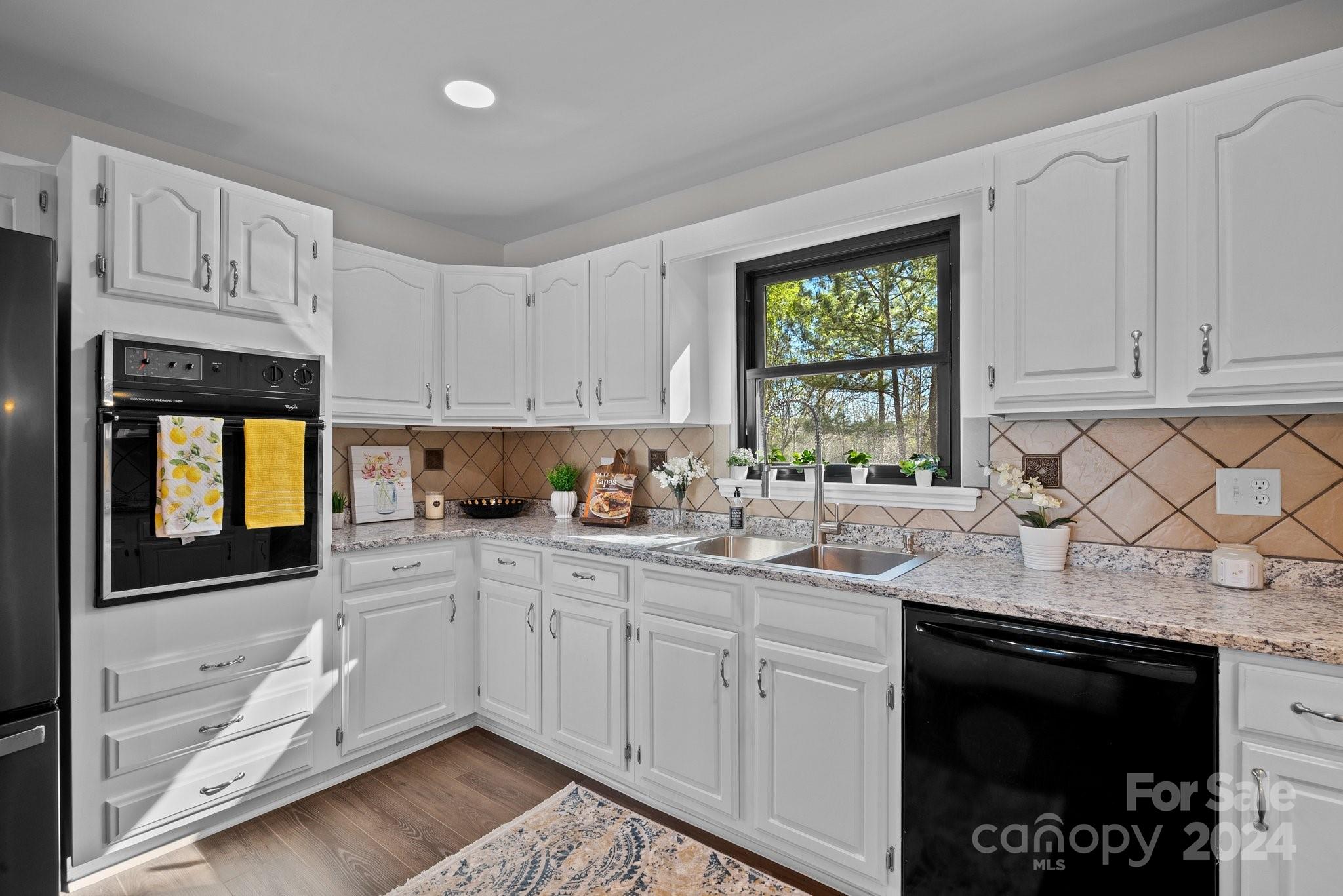 1820 Baber Road, Unit 4 Rutherfordton, NC 28139 - Photo 3 of 28 a kitchen with stainless steel appliances granite countertop a stove a sink and a microwave