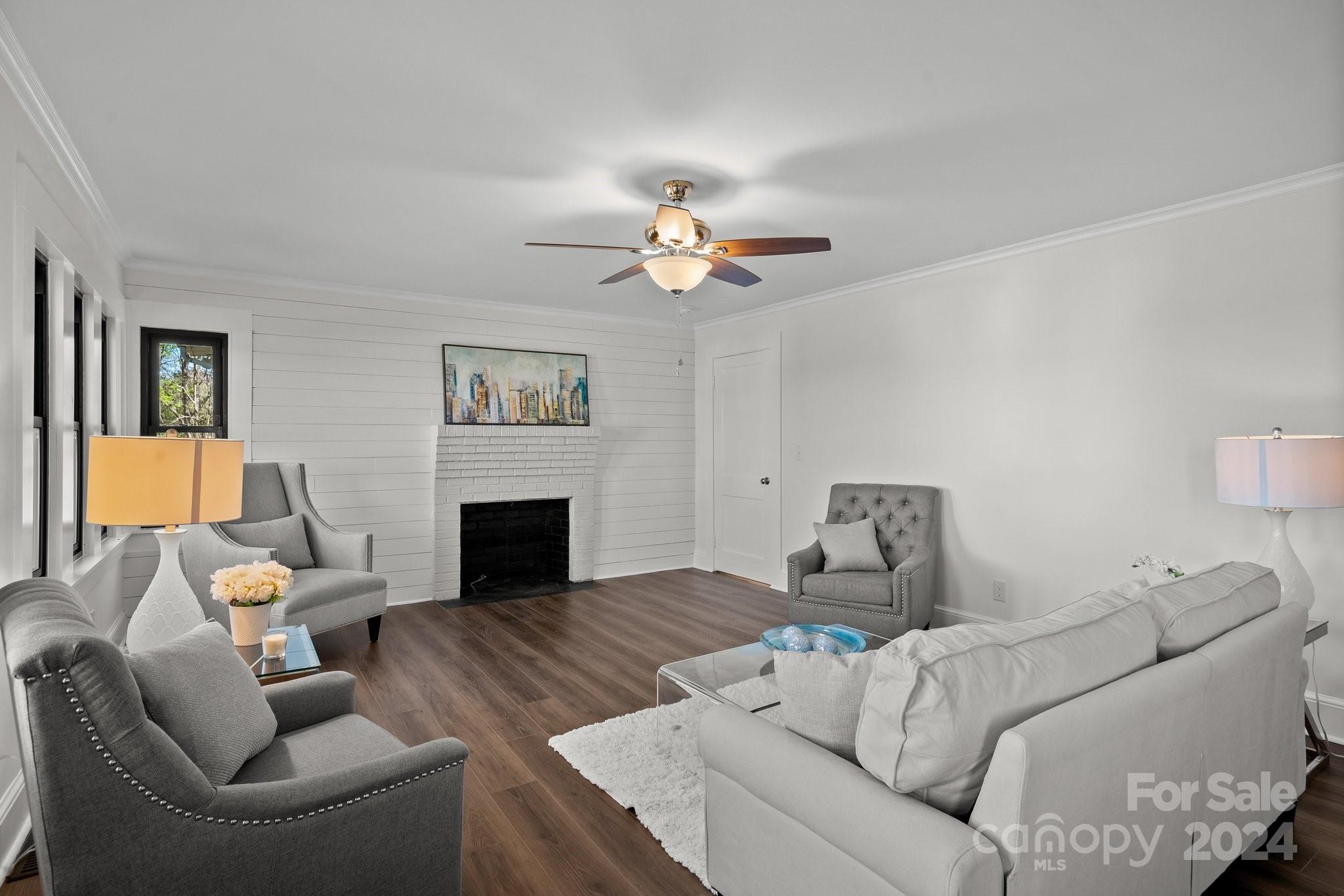1820 Baber Road, Unit 4 Rutherfordton, NC 28139 - Photo 8 of 28 a living room with furniture a fireplace and a chandelier