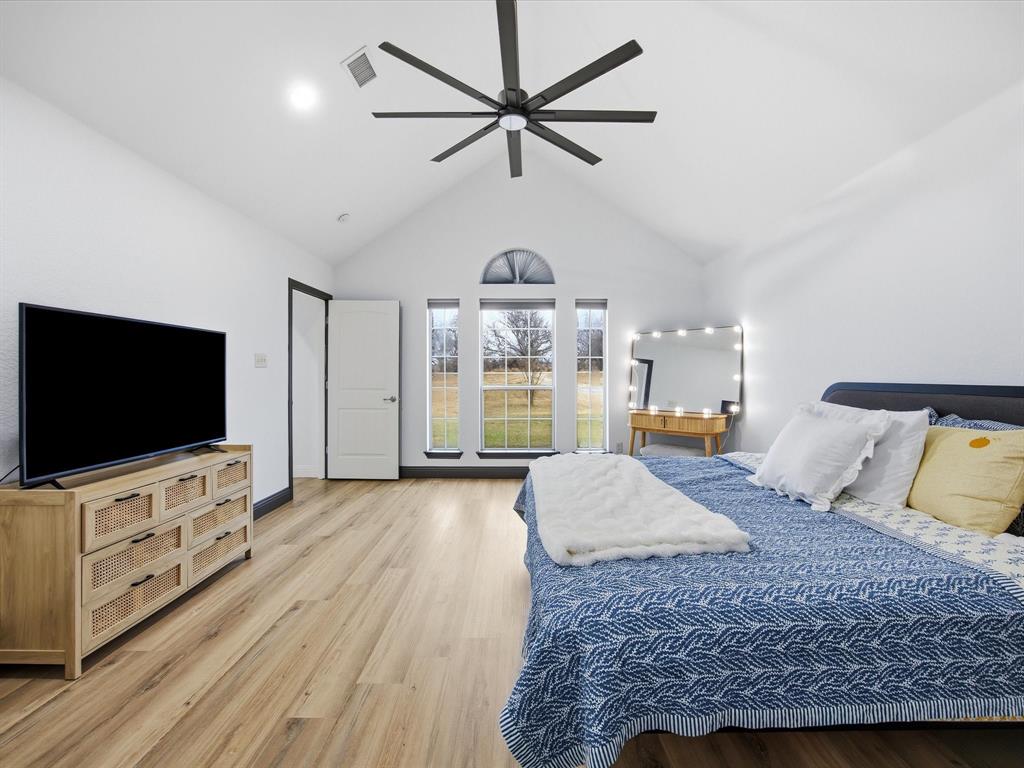 1161 County Road 2175 Decatur, TX 76234 - Photo 12 of 20 a spacious bedroom with a bed and a flat screen tv