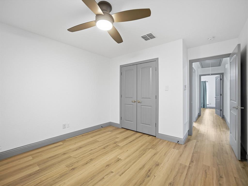 1161 County Road 2175 Decatur, TX 76234 - Photo 16 of 20 an empty room with wooden floor a ceiling fan and closet