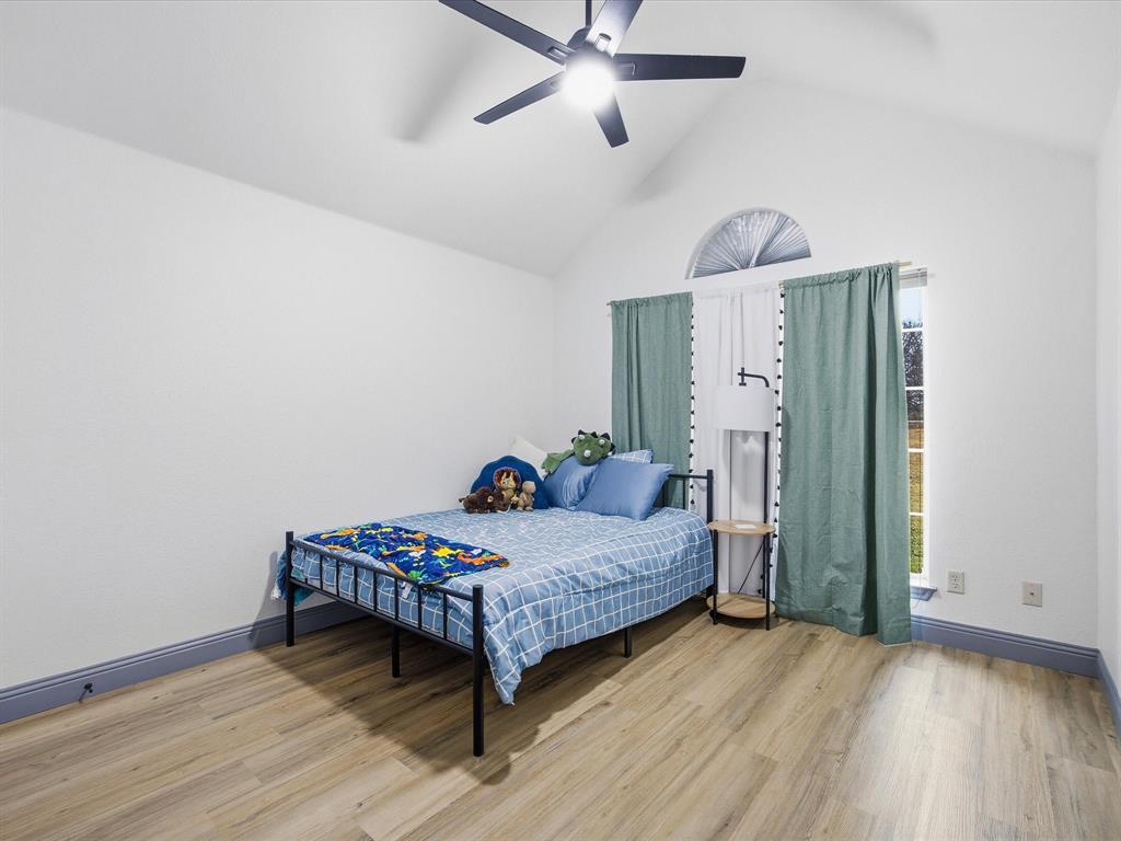 1161 County Road 2175 Decatur, TX 76234 - Photo 17 of 20 a bedroom with a bed and wooden floor