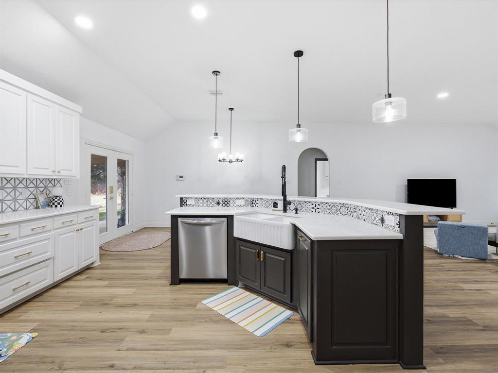 1161 County Road 2175 Decatur, TX 76234 - Photo 9 of 20 a large kitchen with a stove and white cabinets