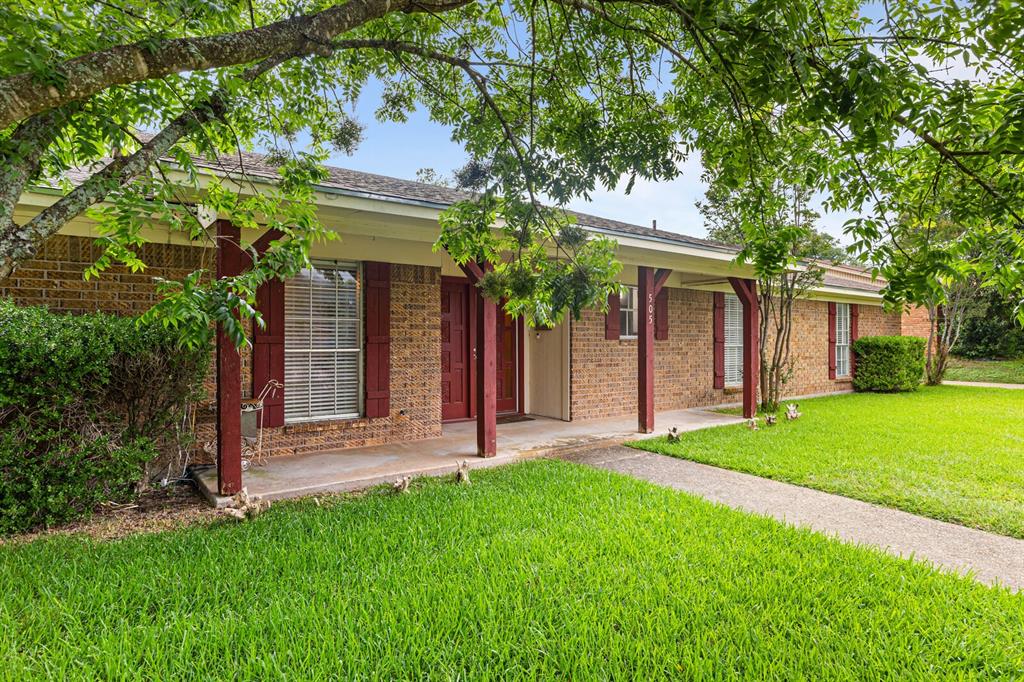 505 Pinewood Lane Hewitt, TX 76643 - Photo 36 of 38 Brick exterior with a covered front porch, red accent shutters, and a concrete walkway