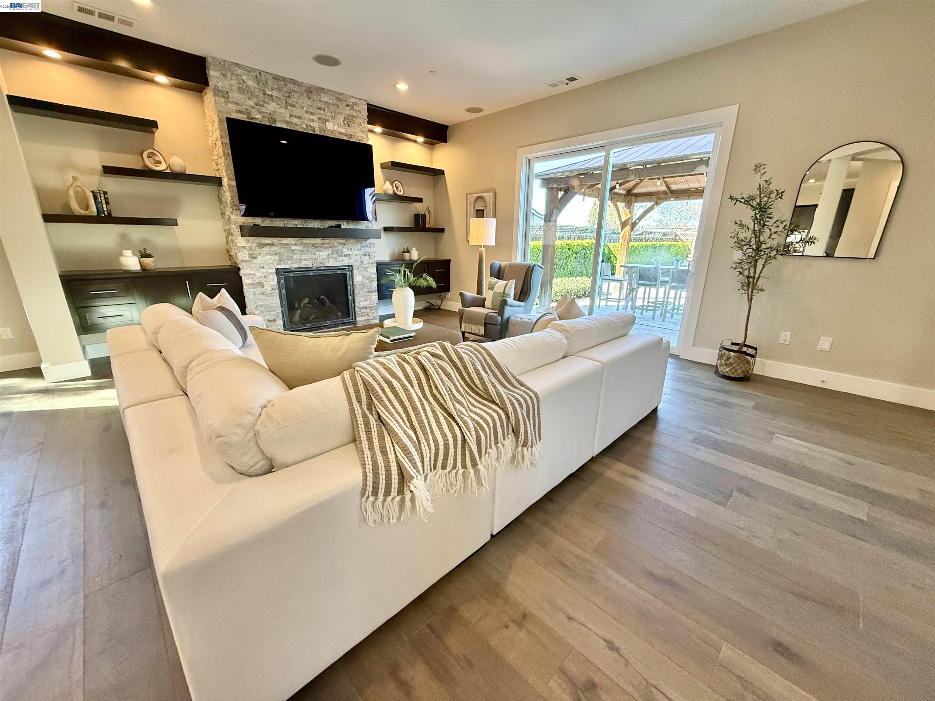 1500 Arroyo Road Livermore, CA 94550 - Photo 11 of 58 a living room with furniture a flat screen tv and a fireplace
