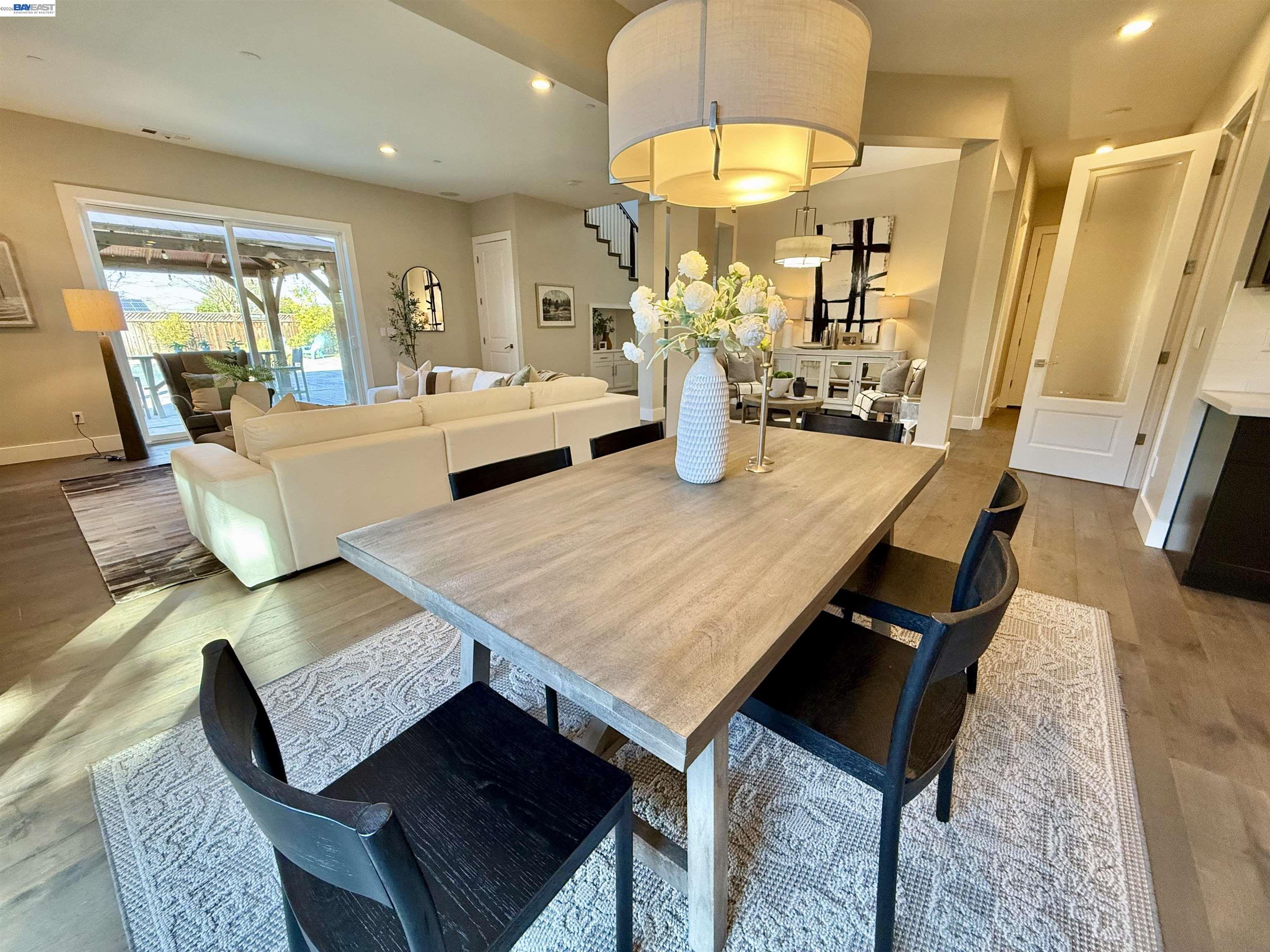 1500 Arroyo Road Livermore, CA 94550 - Photo 17 of 58 a living room with dining table furniture and a wooden floor