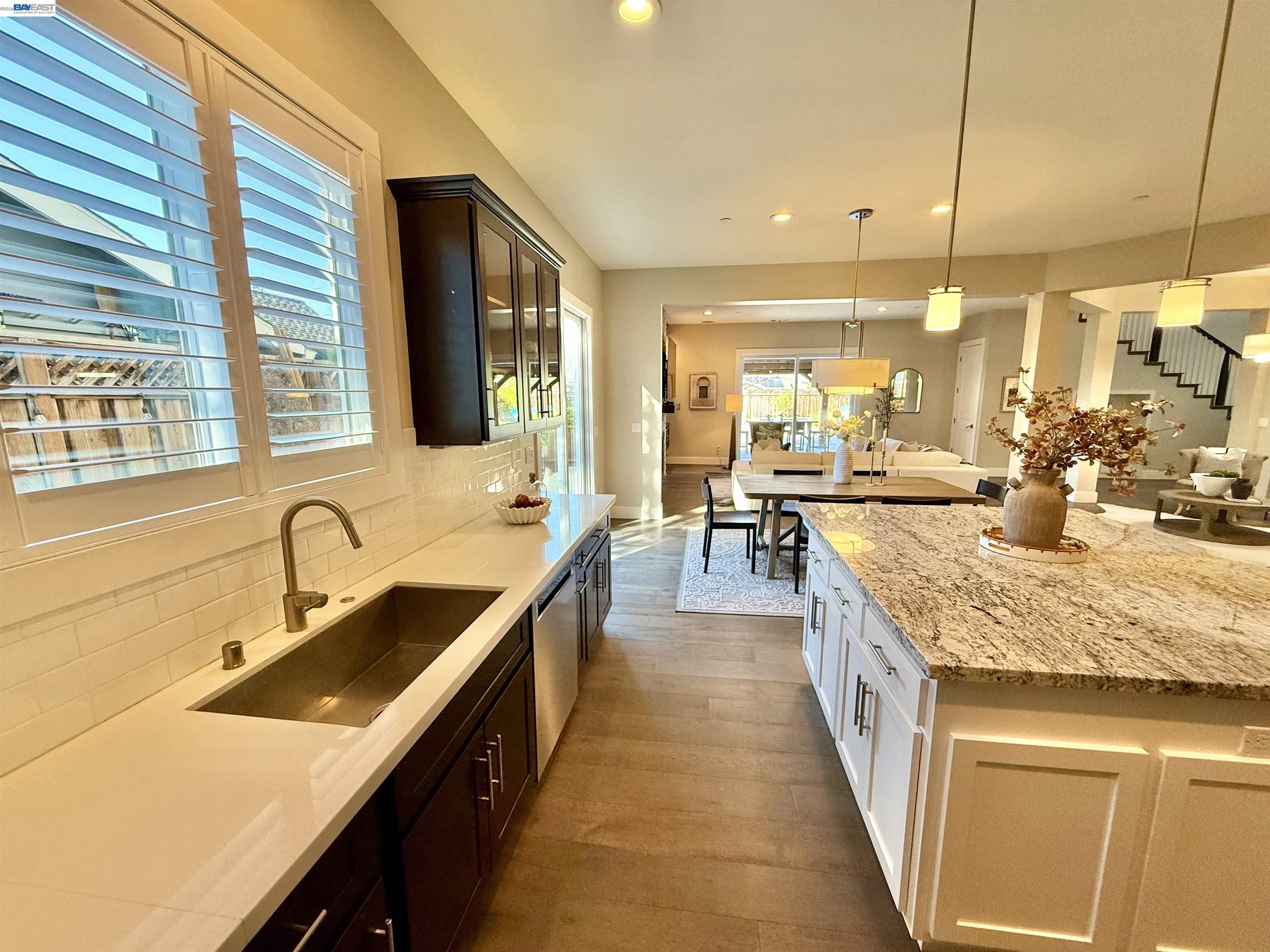 1500 Arroyo Road Livermore, CA 94550 - Photo 20 of 58 a large kitchen with kitchen island a sink a counter space and living room view