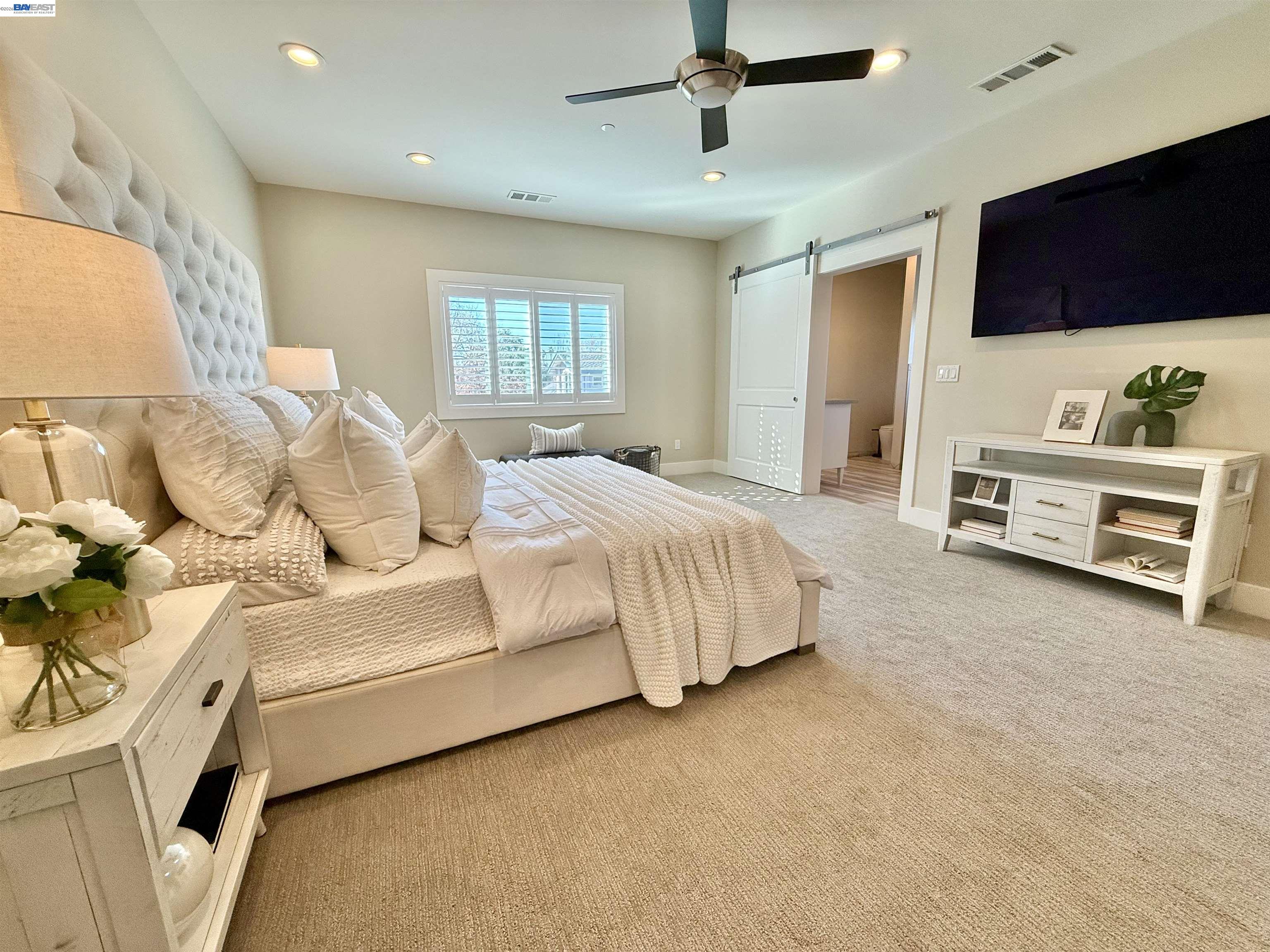 1500 Arroyo Road Livermore, CA 94550 - Photo 34 of 58 a spacious bedroom with a bed and a flat screen tv