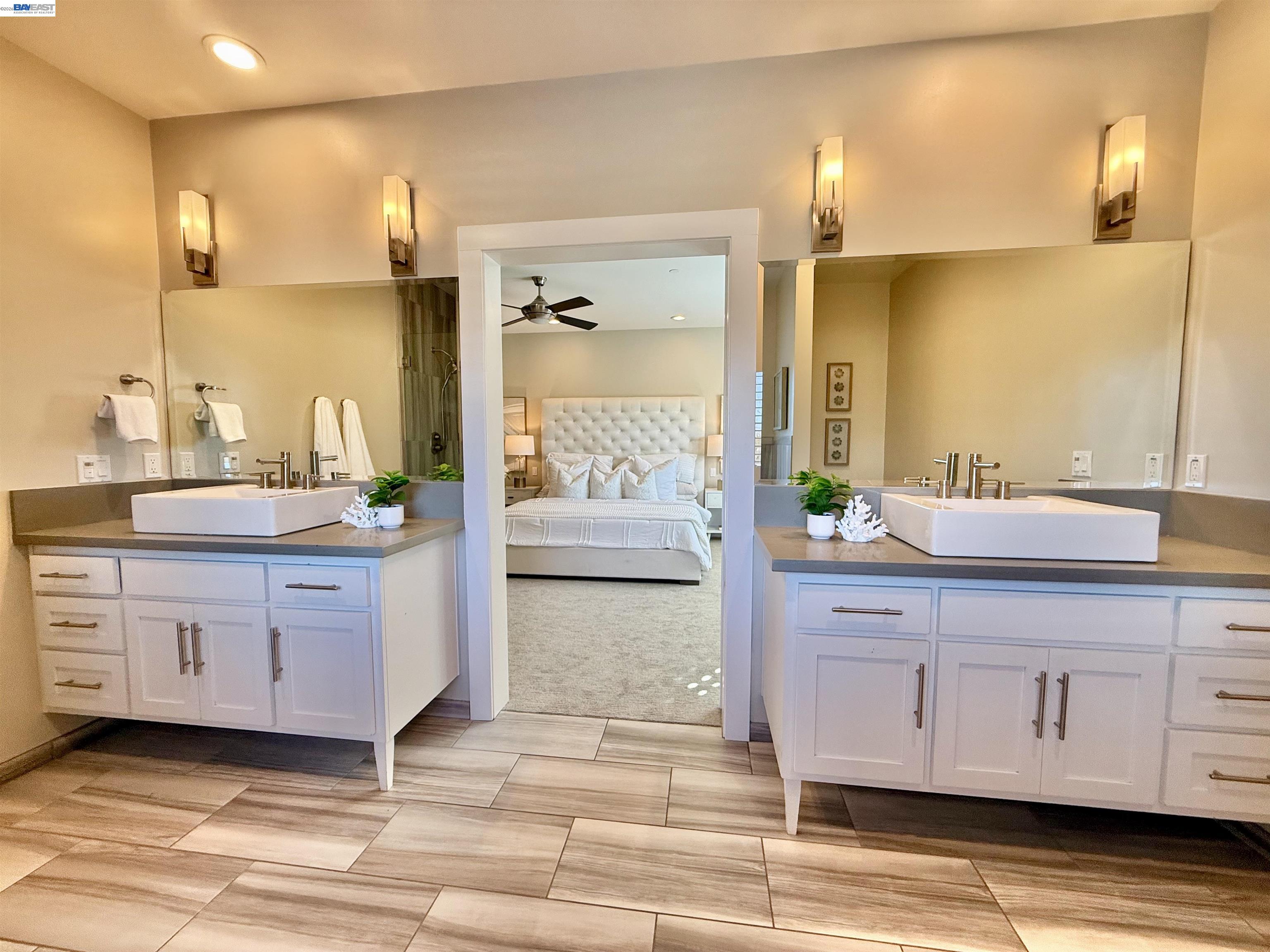 1500 Arroyo Road Livermore, CA 94550 - Photo 37 of 58 a spacious bathroom with a granite countertop sink and a mirror