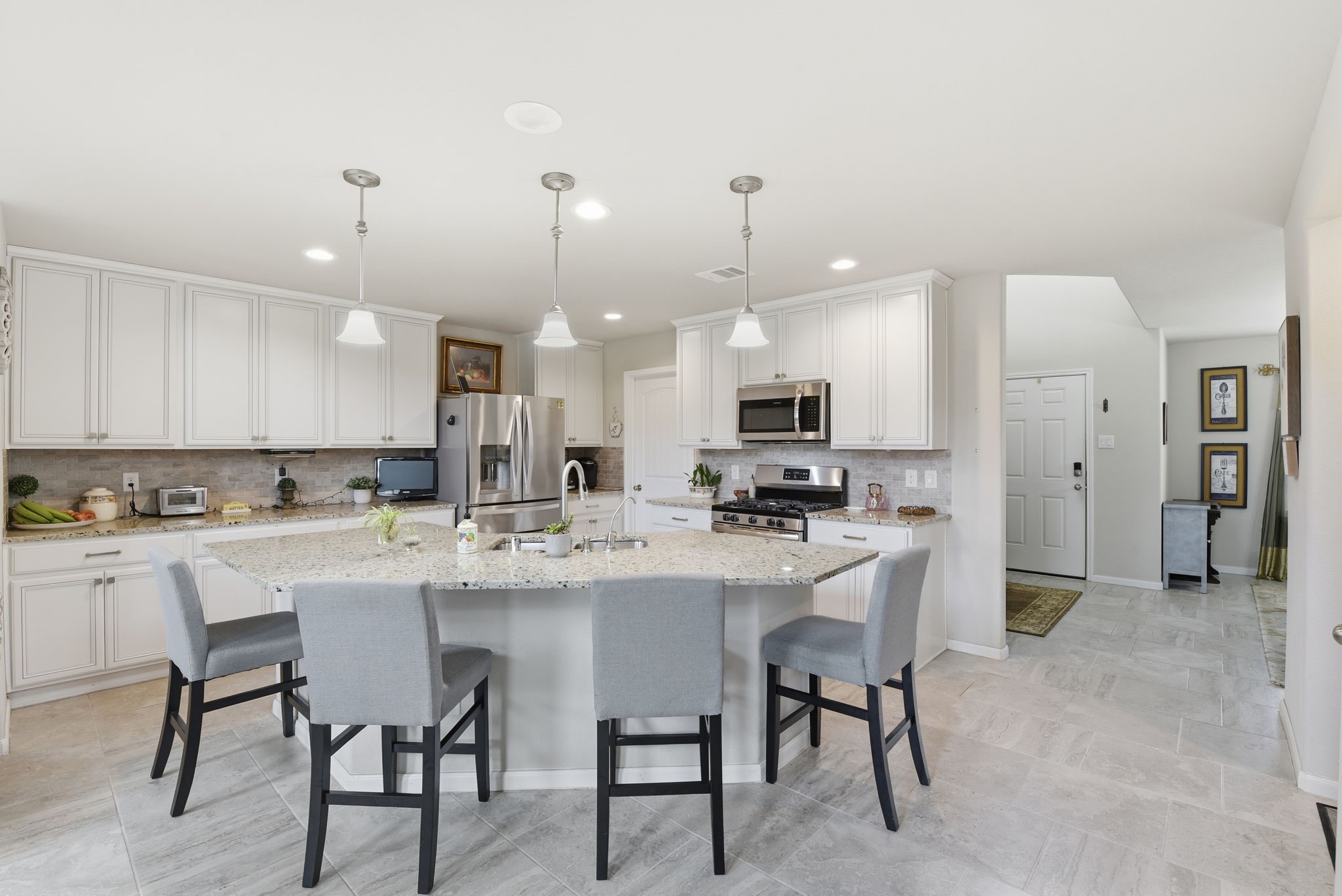 1502 City Lake Place Houston, TX 77047 - Photo 9 of 36 a kitchen with kitchen island cabinets and chairs in it