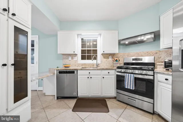 a kitchen with a stove sink and refrigerator