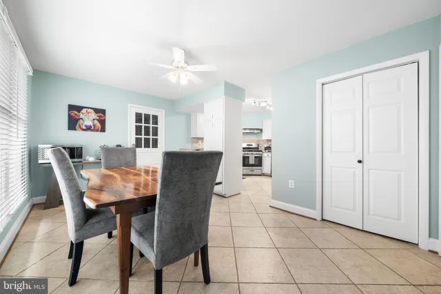 a view of a dining room with furniture and a chandelier