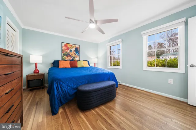 a bathroom with a granite countertop sink a mirror a toilet and shower