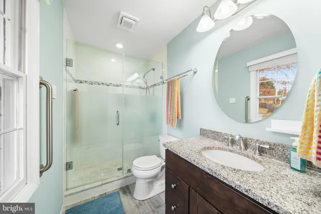 a bedroom with bed and wooden floor