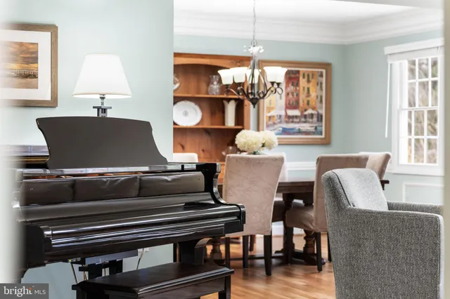 a living room with furniture a window and a chandelier