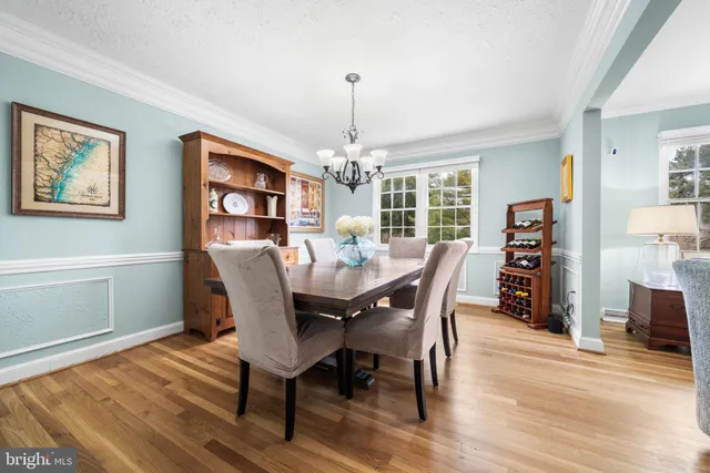 a dining room with furniture window and wooden floor