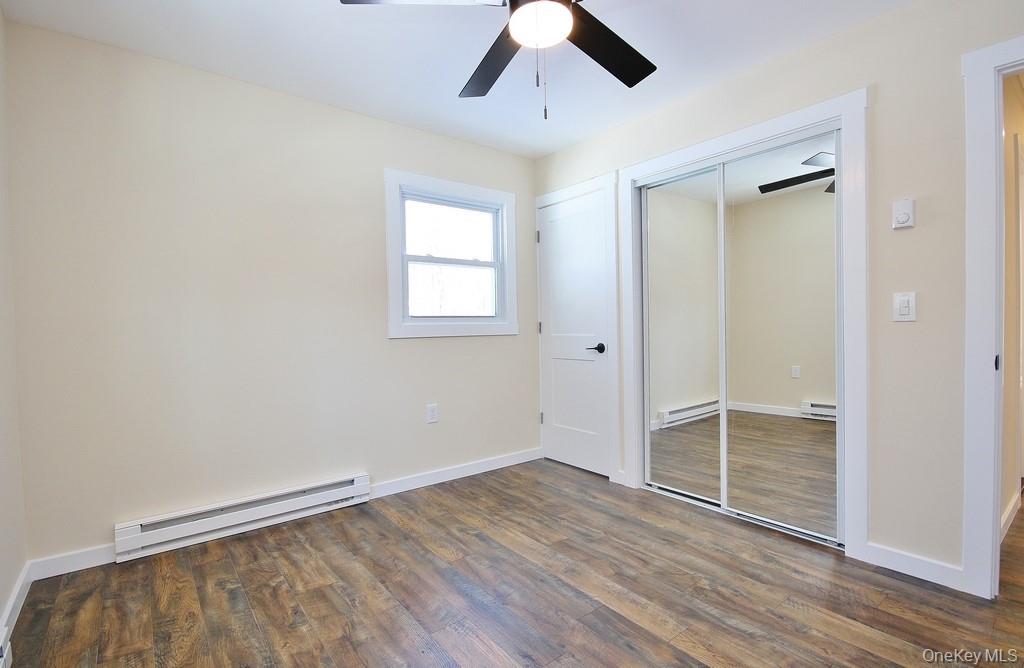 6 Buck Hill Road Wurtsboro, NY 12790 - Photo 35 of 43 an empty room with wooden floor cabinet and windows