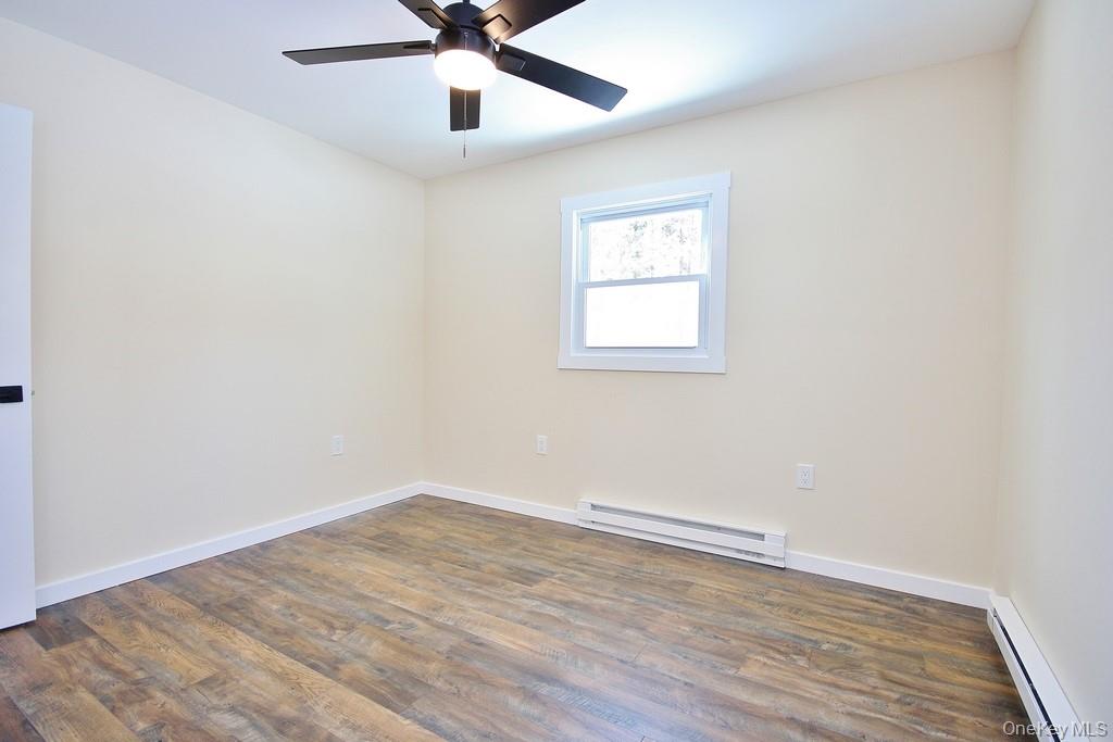 6 Buck Hill Road Wurtsboro, NY 12790 - Photo 37 of 43 an empty room with wooden floor and windows