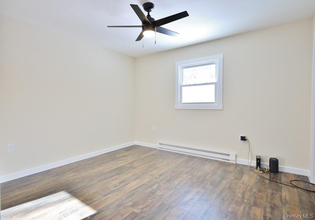 6 Buck Hill Road Wurtsboro, NY 12790 - Photo 38 of 43 an empty room with wooden floor and windows