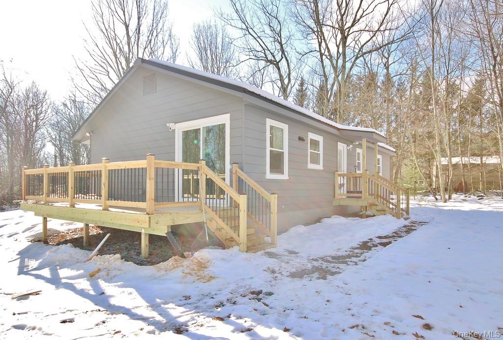 6 Buck Hill Road Wurtsboro, NY 12790 - Photo 4 of 43 a view of a house with a yard covered in snow