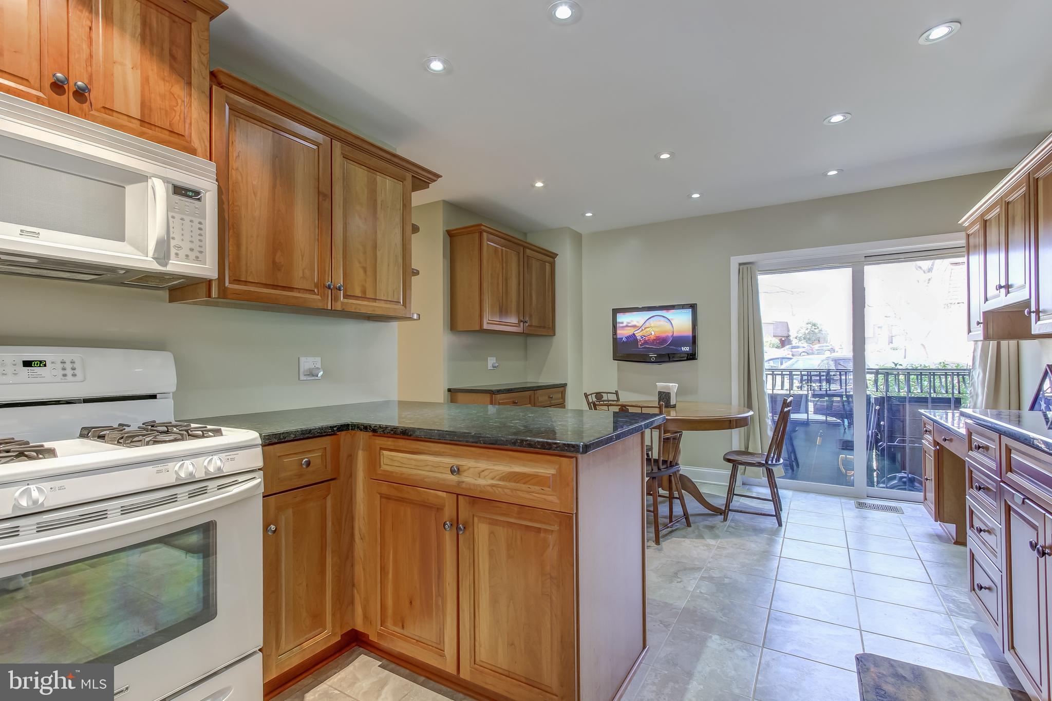 8120 Inverness Ridge Road Potomac, MD 20854 - Photo 13 of 42 a kitchen with granite countertop a sink and a stove