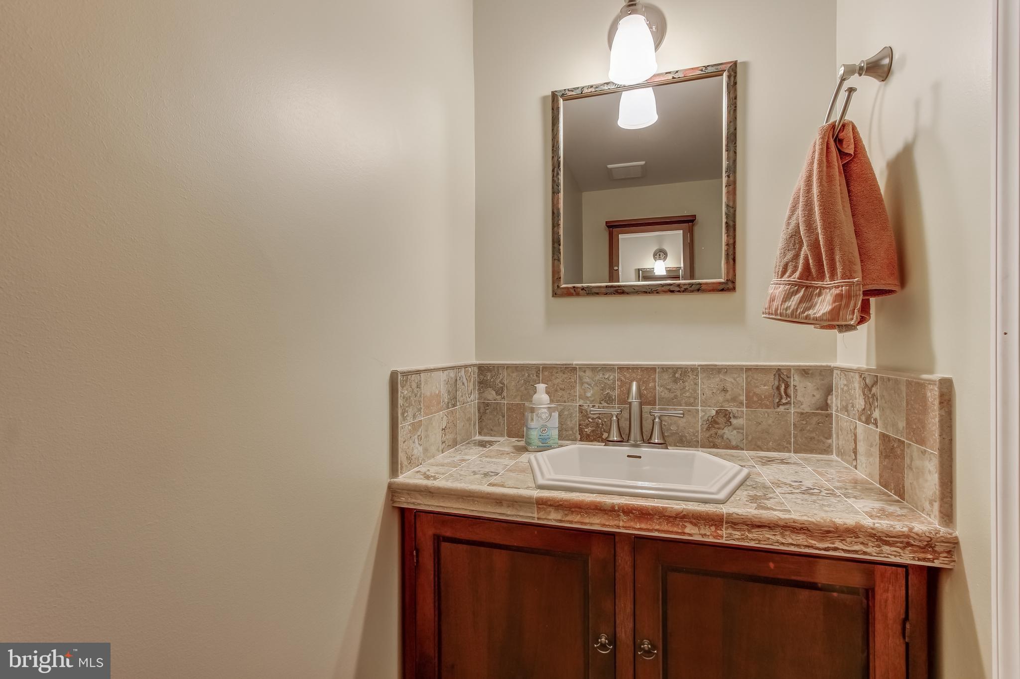 8120 Inverness Ridge Road Potomac, MD 20854 - Photo 22 of 42 a bathroom with a granite countertop sink and a mirror