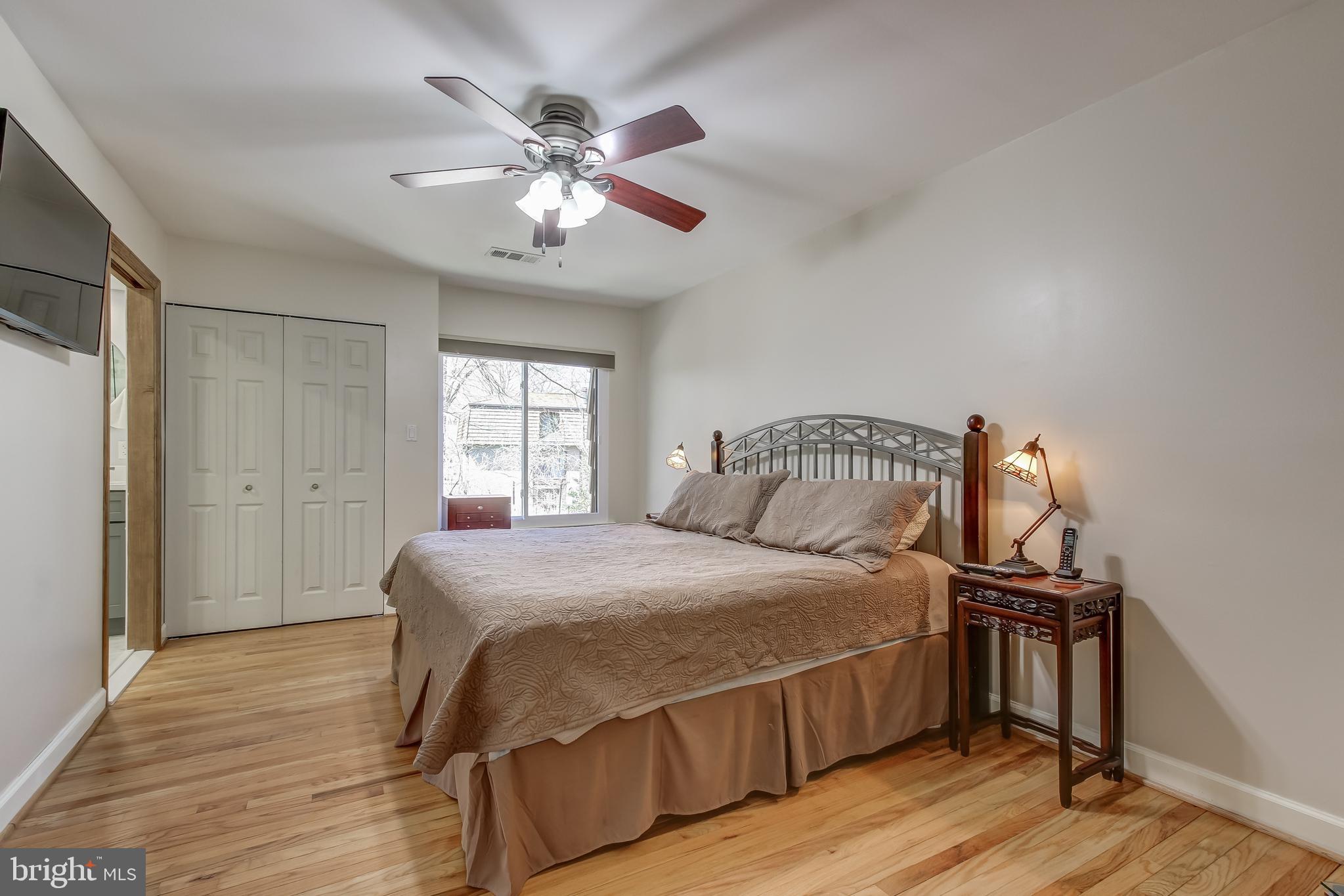 8120 Inverness Ridge Road Potomac, MD 20854 - Photo 28 of 42 a bedroom with a bed and wooden floor